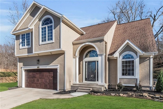 view of front facade featuring an attached garage, fence, driveway, roof with shingles, and stucco siding