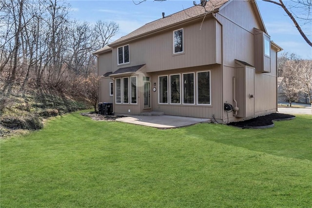 back of property with a patio and a lawn