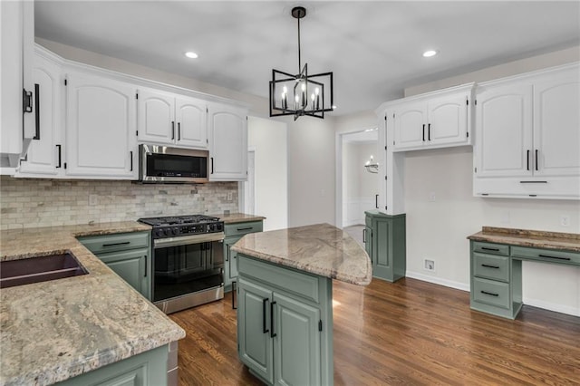 kitchen featuring white cabinetry, stainless steel microwave, green cabinets, and gas range oven