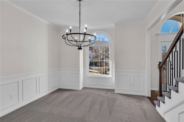 unfurnished dining area featuring a chandelier, visible vents, stairway, carpet, and crown molding