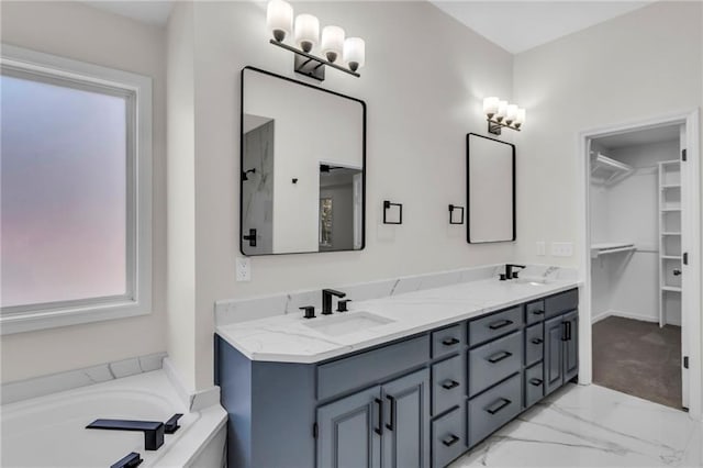 full bath with a garden tub, marble finish floor, double vanity, and a sink