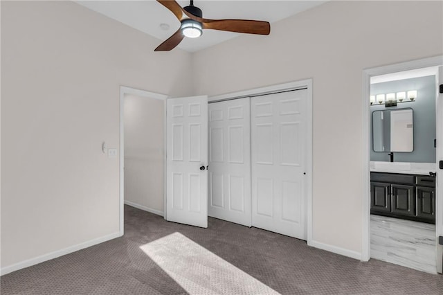 unfurnished bedroom with carpet floors, baseboards, and a closet