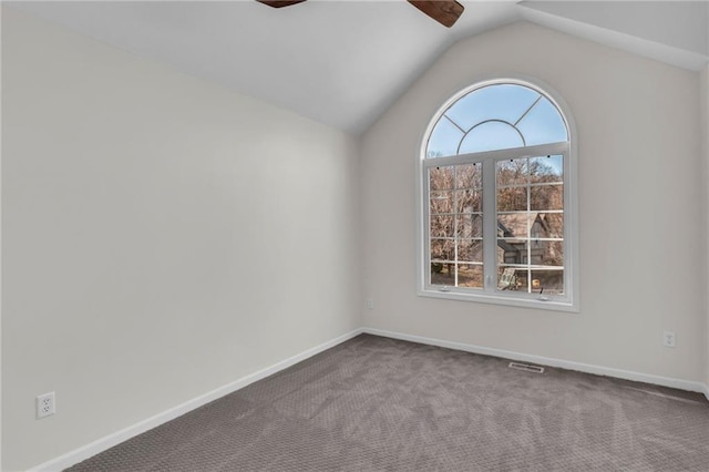 spare room featuring visible vents, baseboards, lofted ceiling, ceiling fan, and carpet