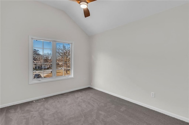 unfurnished room with baseboards, visible vents, a ceiling fan, lofted ceiling, and dark carpet