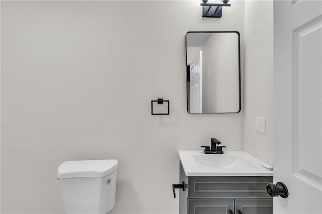 half bathroom with toilet and vanity