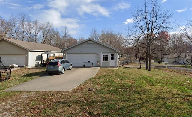 view of home's exterior with a yard, an outdoor structure, and a detached garage