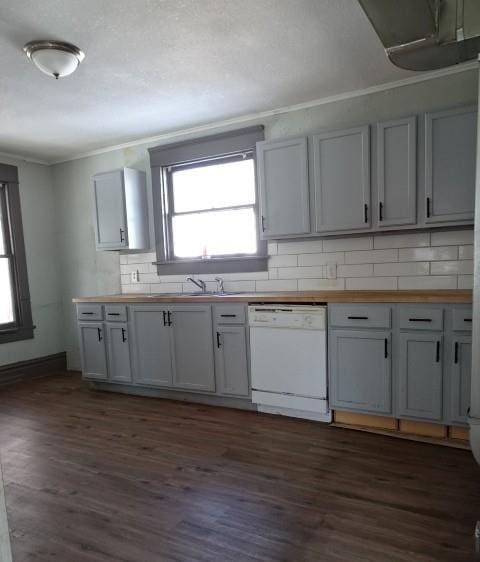 kitchen featuring dishwasher, butcher block countertops, and a healthy amount of sunlight