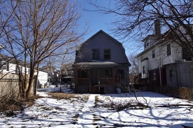 view of front of home featuring covered porch and a gambrel roof