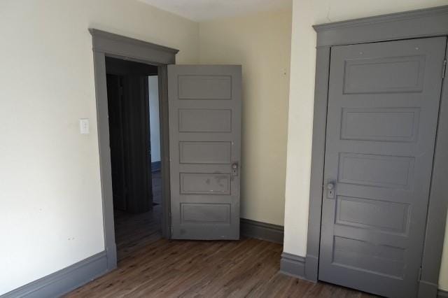 interior space featuring baseboards and wood finished floors