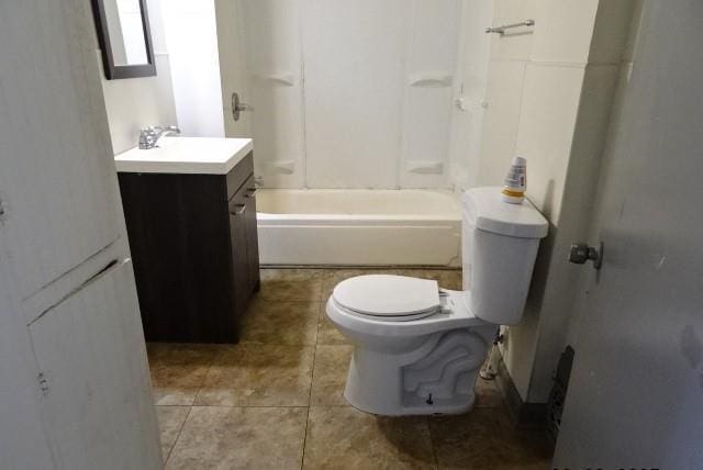 bathroom featuring washtub / shower combination, vanity, tile patterned flooring, and toilet