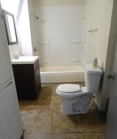 full bathroom featuring washtub / shower combination, vanity, tile patterned flooring, and toilet