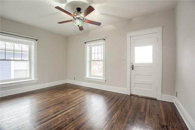 entrance foyer with a ceiling fan, dark wood-style floors, and baseboards