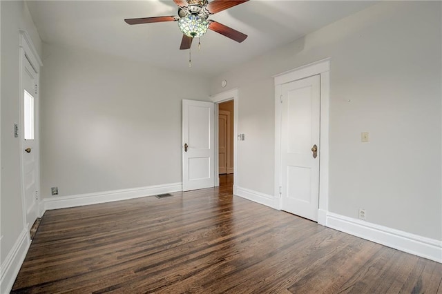 unfurnished bedroom with visible vents, ceiling fan, baseboards, and wood finished floors