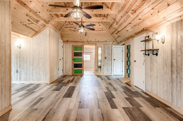 bonus room with a ceiling fan, wood finished floors, lofted ceiling, wood walls, and wooden ceiling