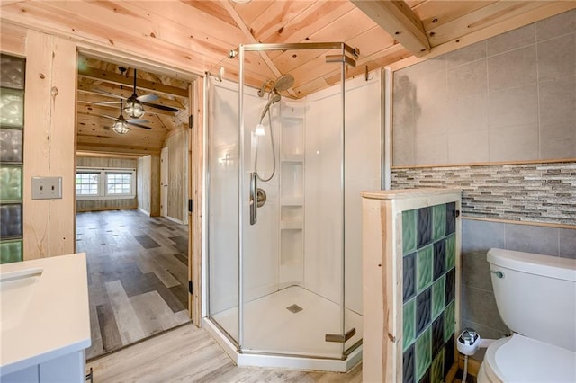 full bathroom featuring a ceiling fan, a shower stall, wood finished floors, and wood ceiling