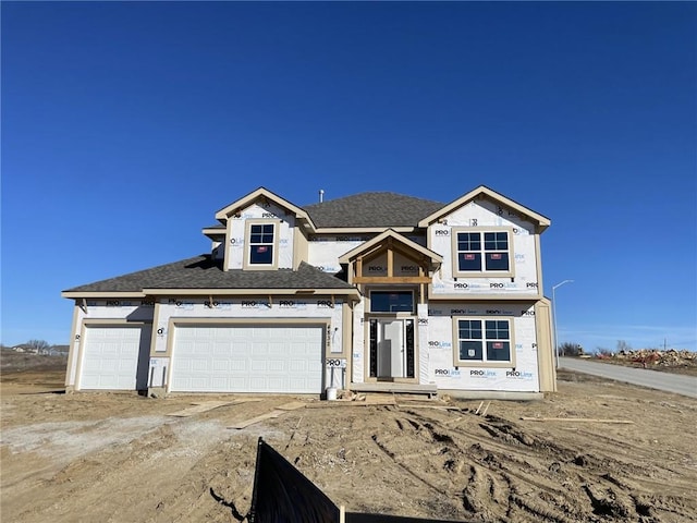 unfinished property featuring an attached garage and dirt driveway