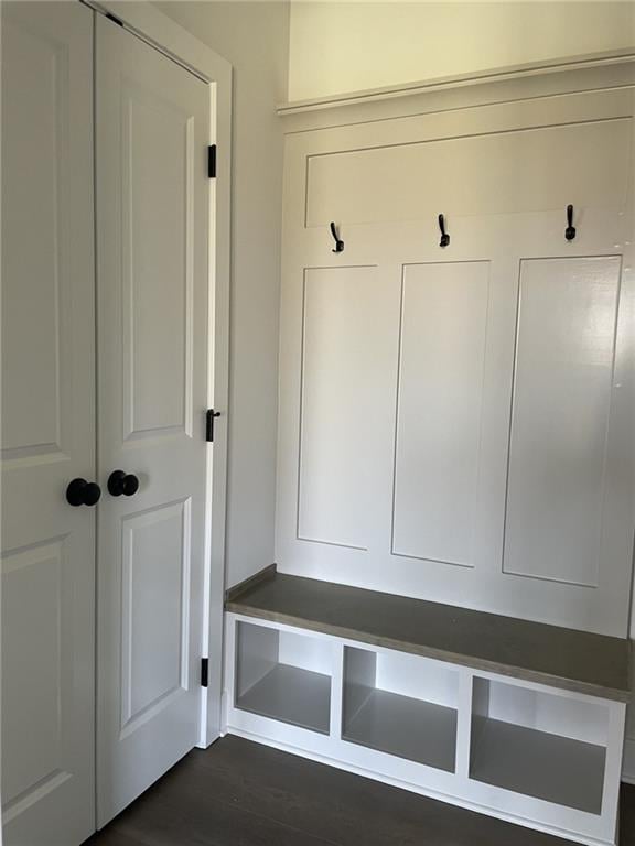 mudroom with dark wood finished floors