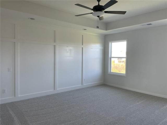 unfurnished bedroom featuring carpet floors, baseboards, visible vents, and ceiling fan