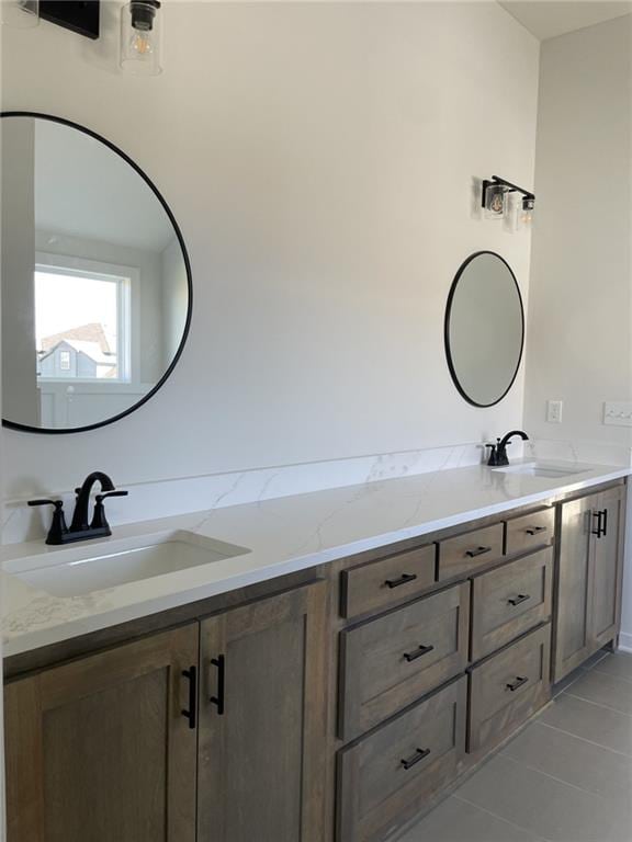 full bathroom with tile patterned floors, a sink, and double vanity