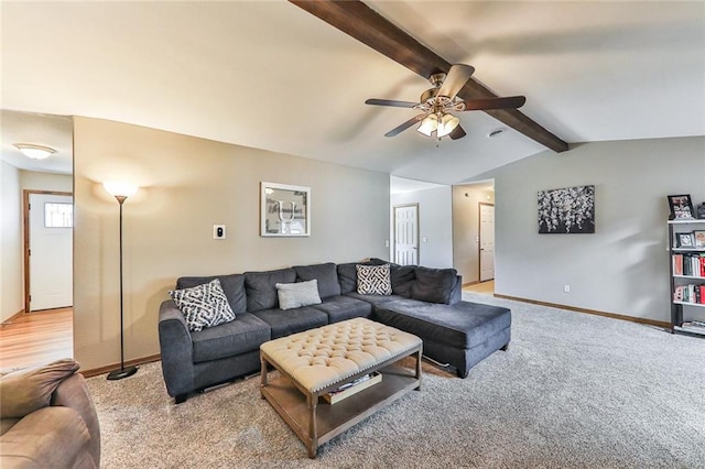 living area featuring lofted ceiling with beams, ceiling fan, carpet flooring, and baseboards