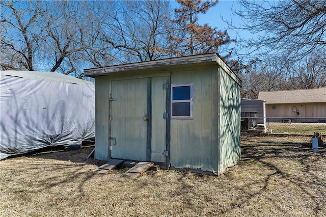 view of shed with fence