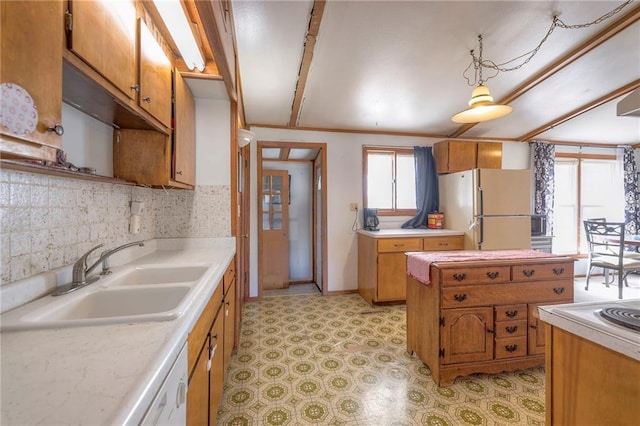 kitchen featuring a wealth of natural light, white appliances, light countertops, and a sink