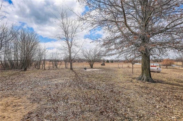 view of yard with a rural view and fence