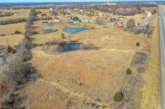 aerial view with a water view and a rural view