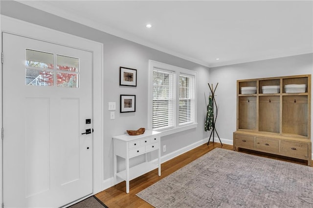 foyer featuring ornamental molding, recessed lighting, baseboards, and wood finished floors