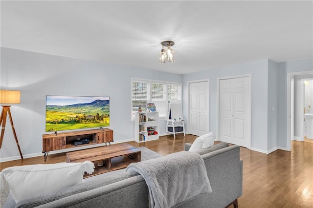 living room featuring baseboards and wood finished floors