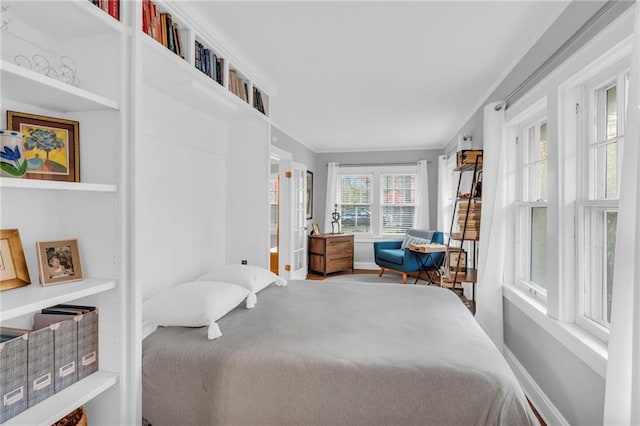 bedroom with baseboards and ornamental molding