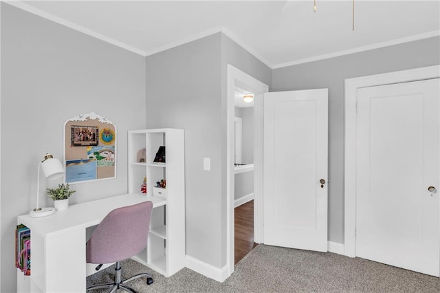 office space with ornamental molding, carpet, and baseboards