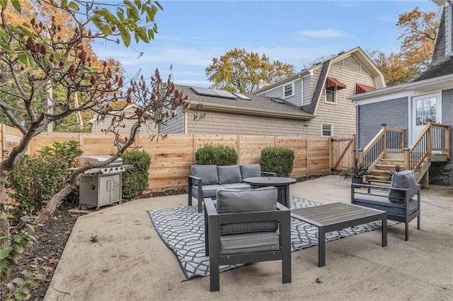 view of patio / terrace with grilling area, an outdoor hangout area, and a fenced backyard