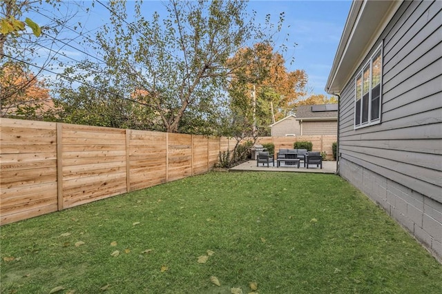 view of yard featuring a patio area, a fenced backyard, and an outdoor hangout area