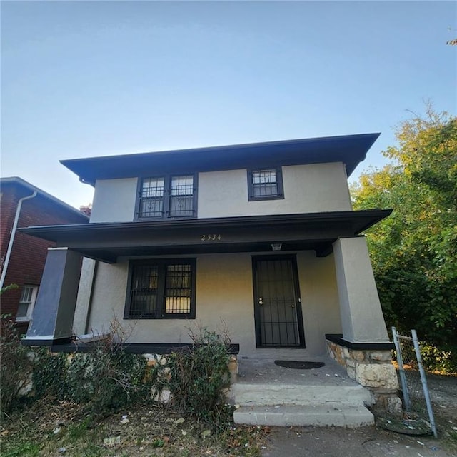 view of front of home featuring stucco siding and covered porch