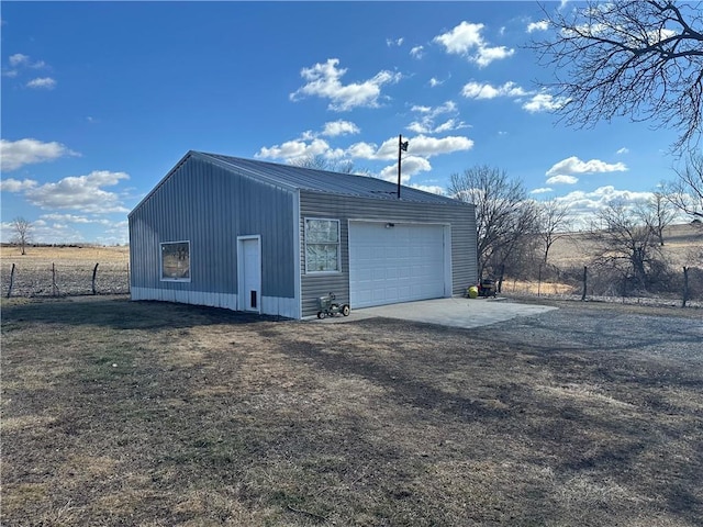 detached garage featuring fence