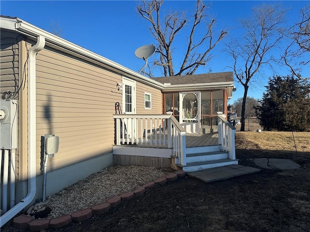 exterior space with a sunroom and a deck