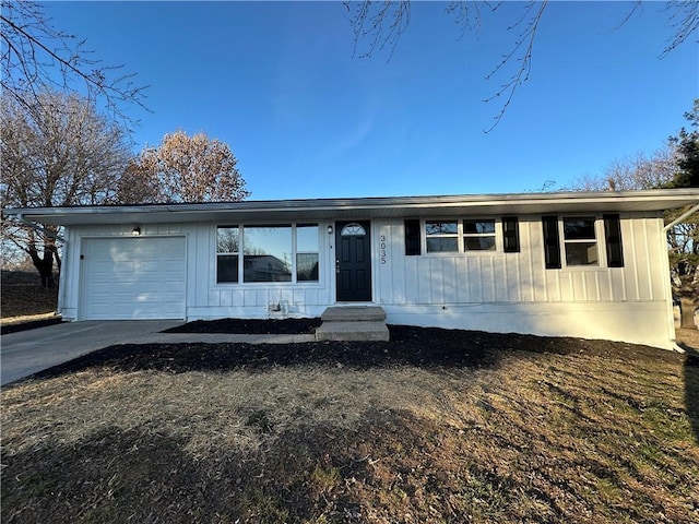 view of front facade featuring a garage, driveway, and board and batten siding