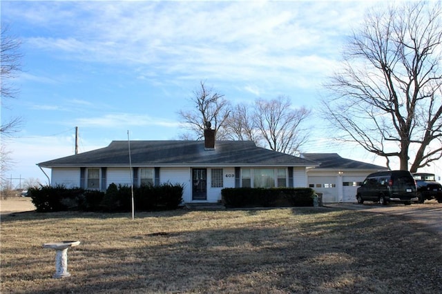 single story home featuring a garage and a front yard