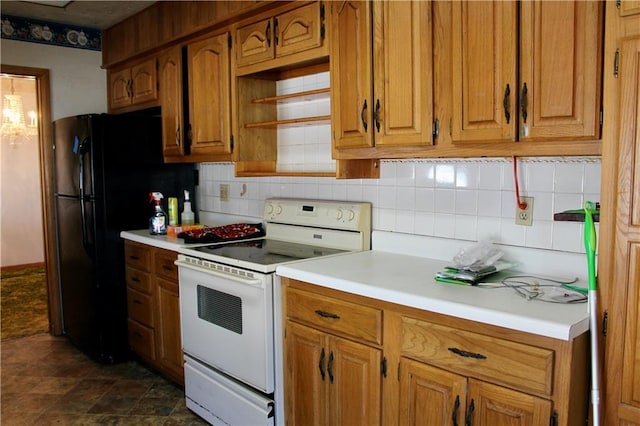 kitchen with electric range, light countertops, and backsplash