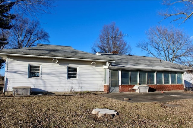 back of house featuring a patio area and brick siding