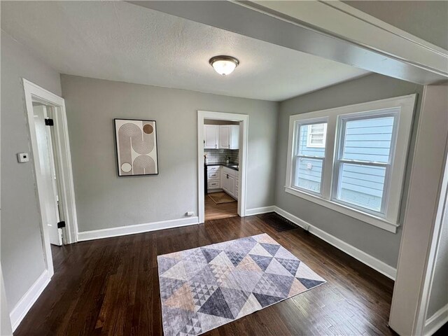 3003 E 52nd St, Kansas City, MO 64130 - interior space with dark wood-style flooring and baseboards