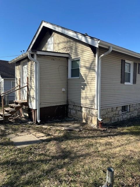 view of side of home featuring entry steps