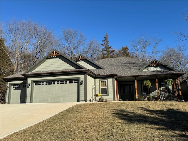 view of front of house with concrete driveway, roof with shingles, an attached garage, covered porch, and a front lawn