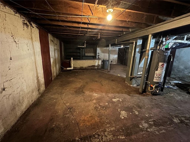 unfinished basement featuring gas water heater