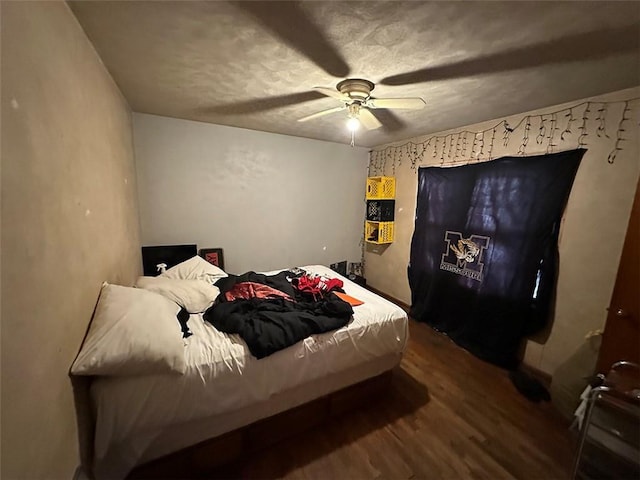 bedroom with a ceiling fan and wood finished floors