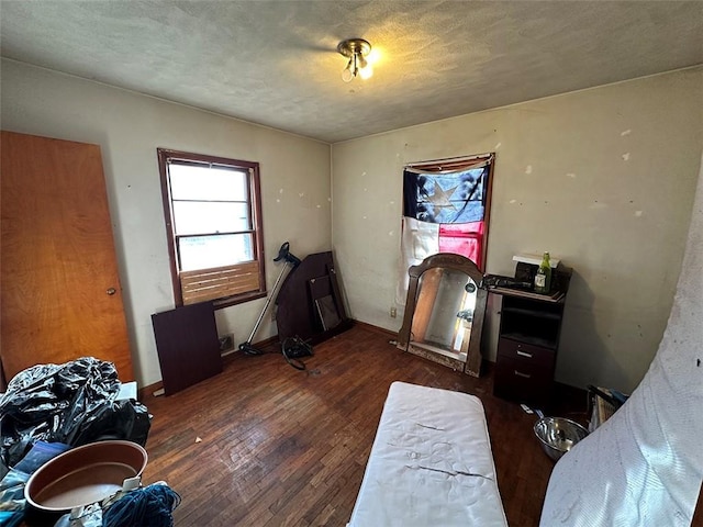 bedroom featuring wood finished floors and baseboards