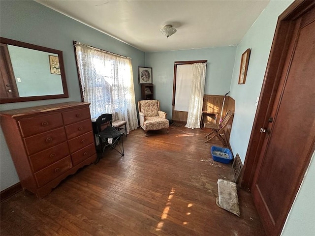 sitting room with baseboards and wood finished floors