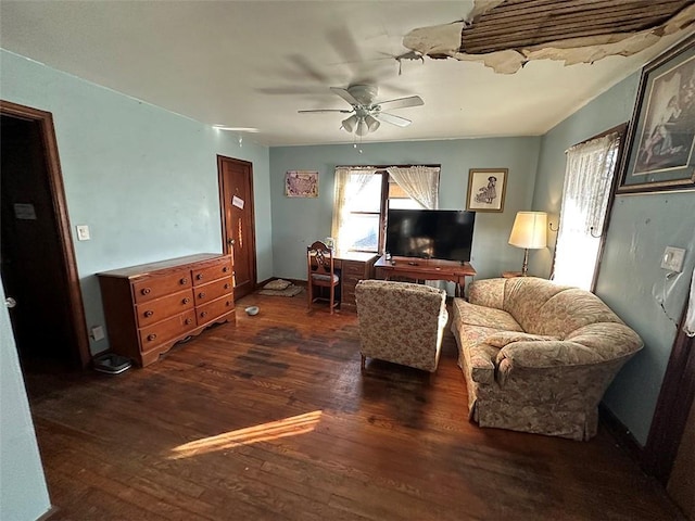 living area with ceiling fan, baseboards, and wood finished floors