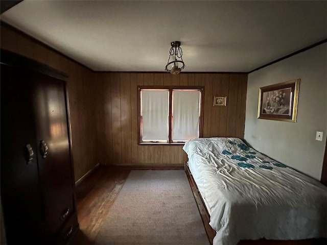 bedroom featuring wooden walls and wood finished floors